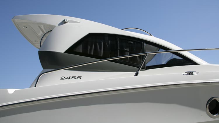 One-piece, double-skin composite roof shell with spoiler extending over aft cockpit